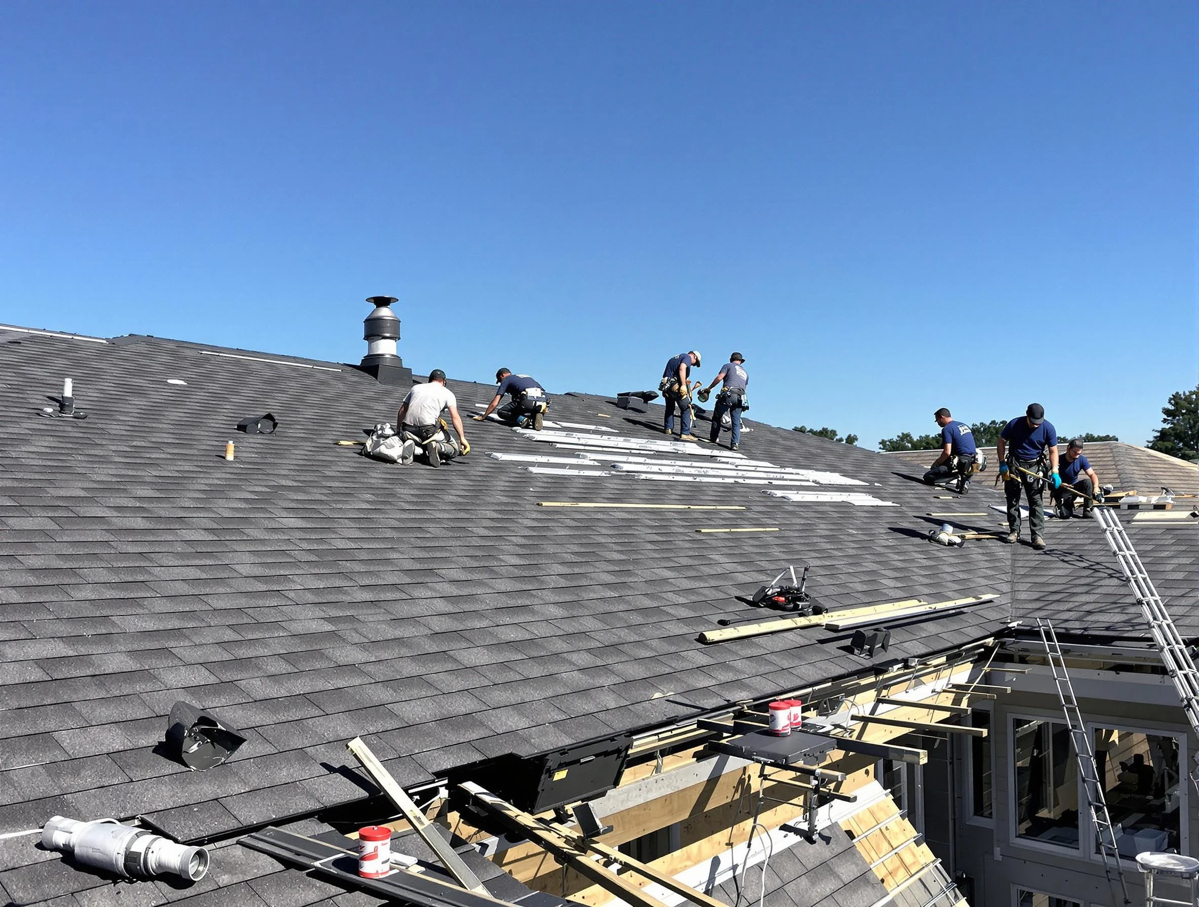 YICN roofing crew installing new architectural shingles on a large residential roof