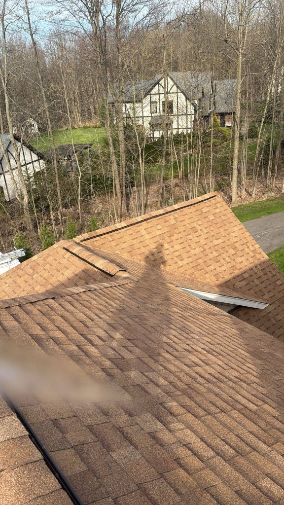 After: Completed roof installation with beautiful brown shingles